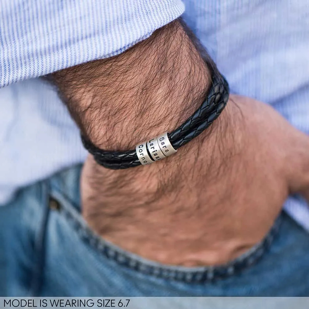 Man wearing a braided leather bracelet with inscribed custom silver beads 