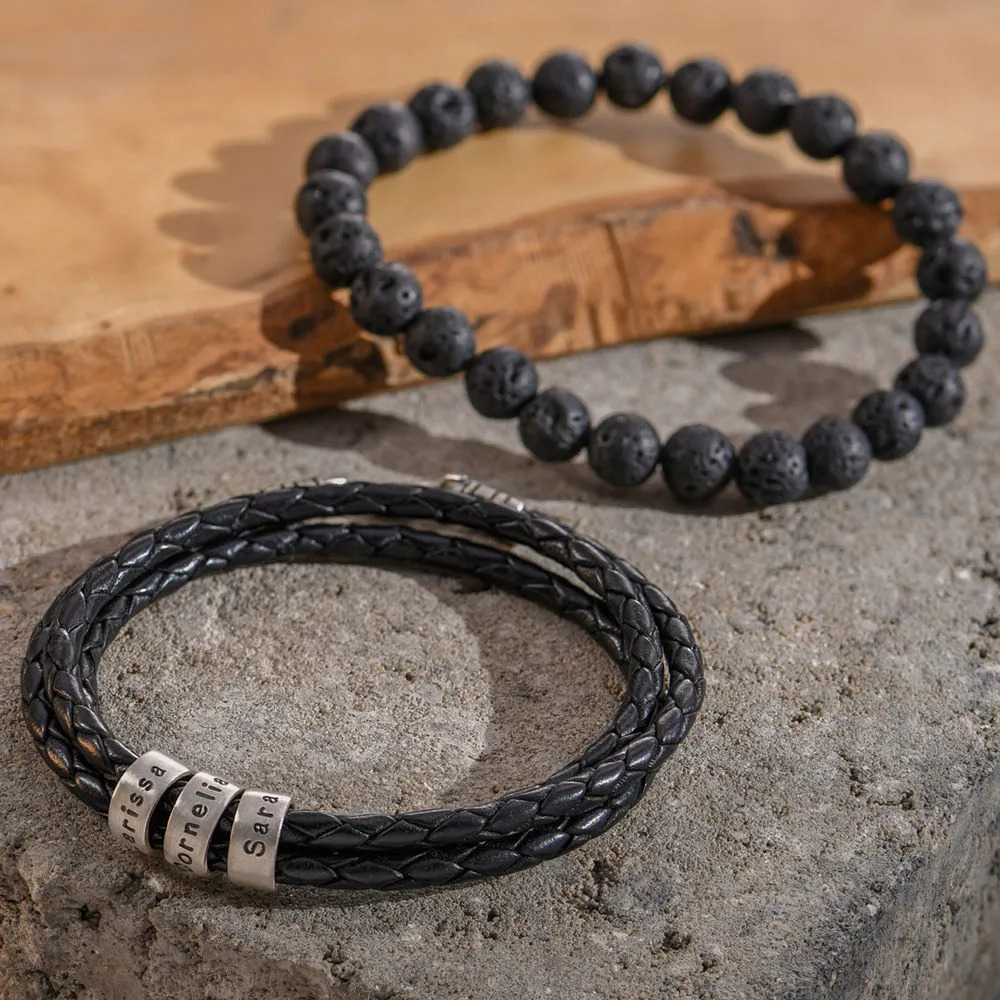 Stock image of braided leather bracelet and beads bracelet on a wood and concrete background 