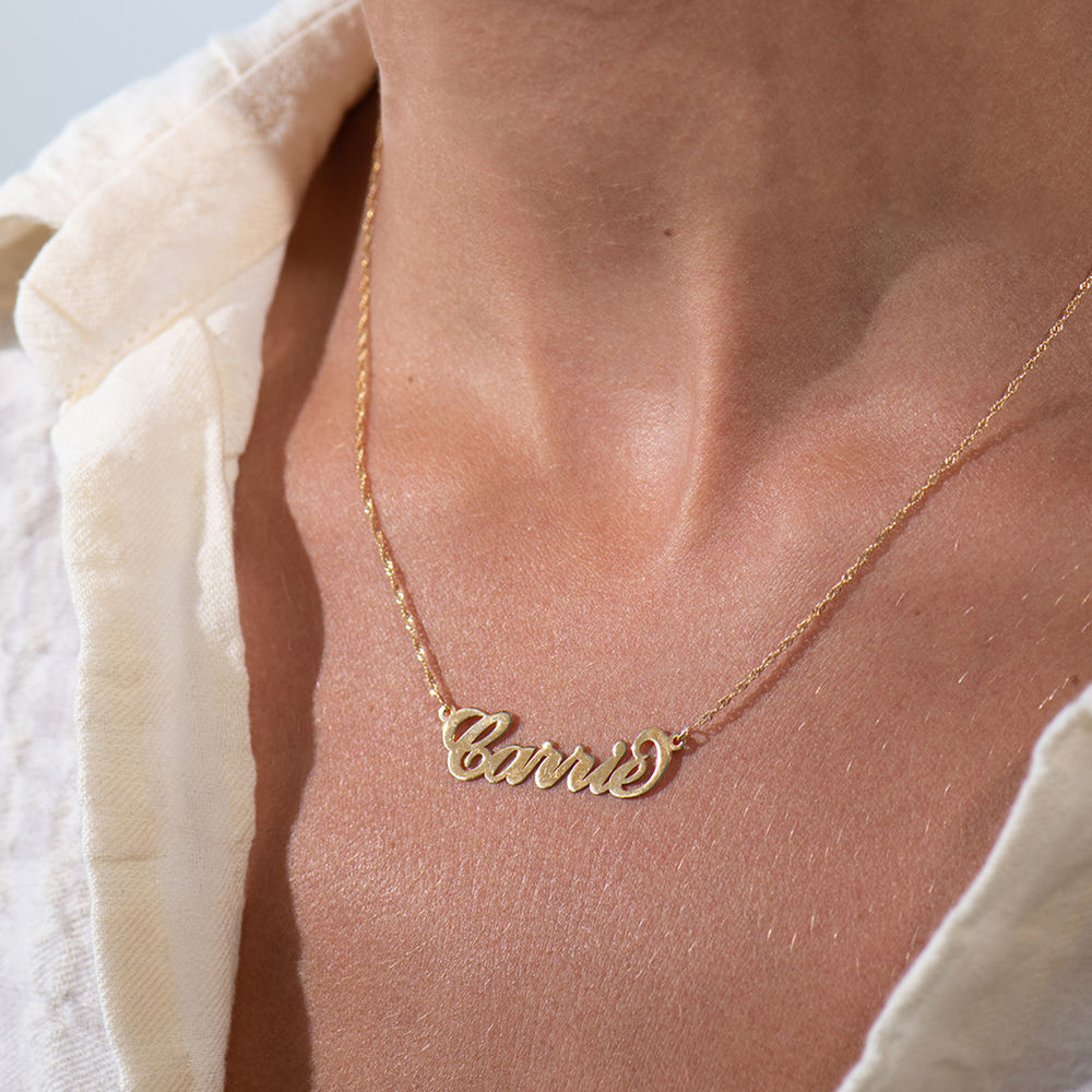 Personalized 14k Gold Carrie Name Necklace around a woman's neck