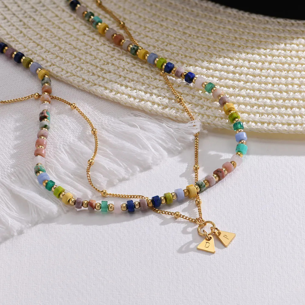 Resort Layered Beads Necklace resting on hat in the background