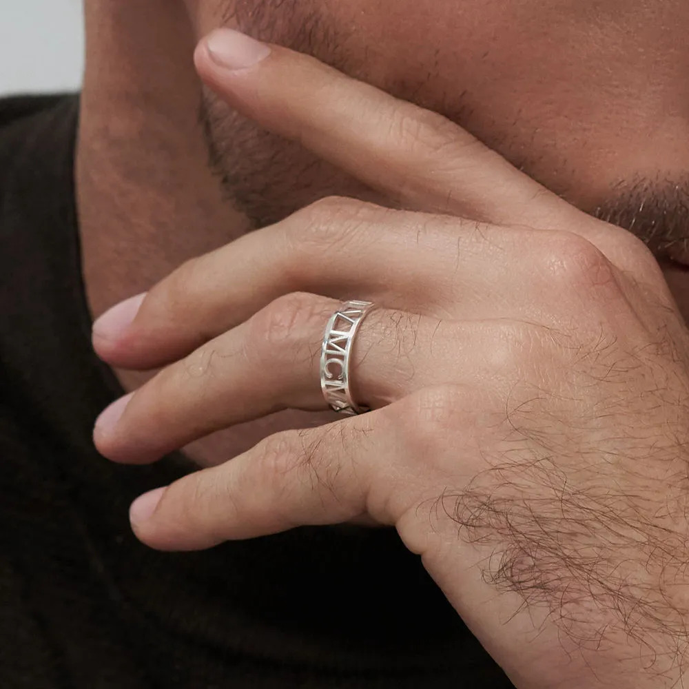 A man wearing a sterling silver ring with Roman numeral s