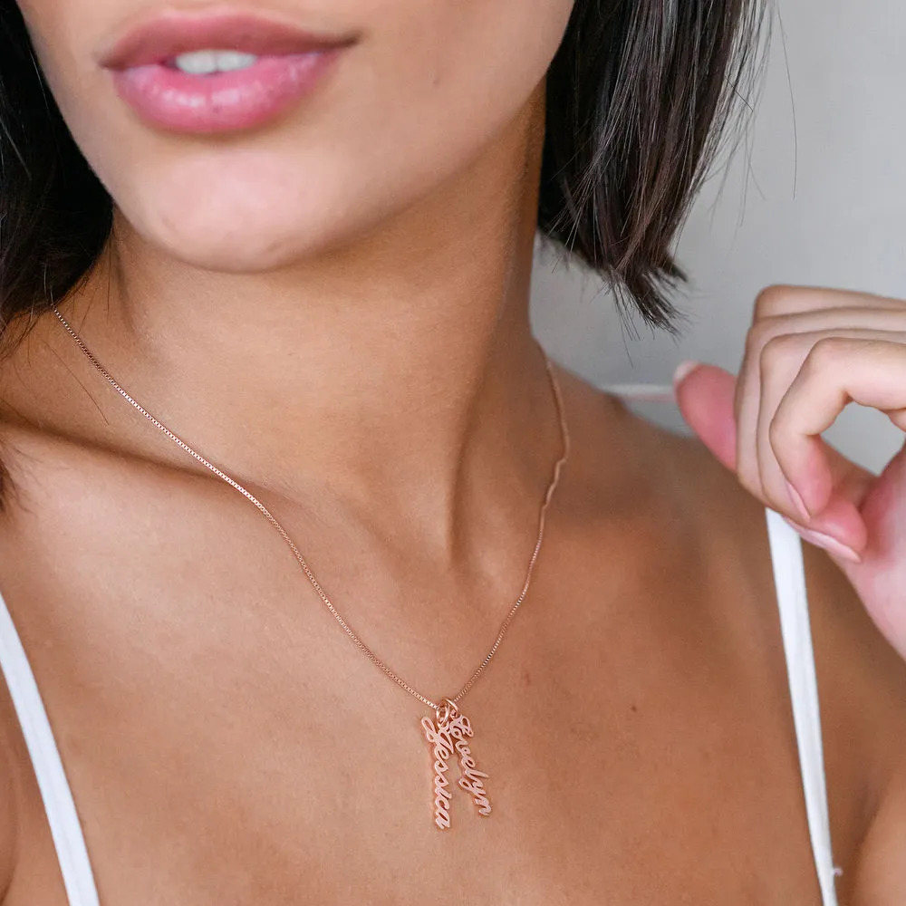 Woman wearing a rose gold plated necklace with a name pendant  around her neck 