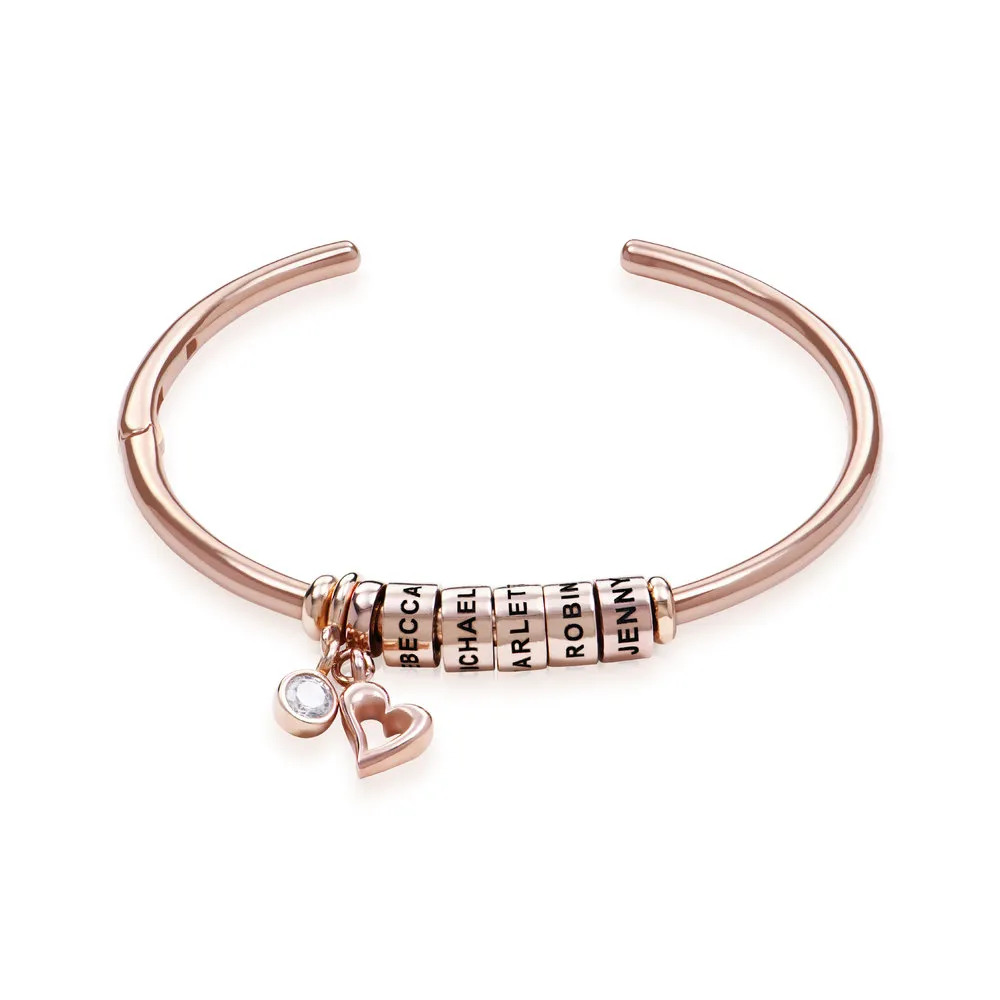 Stock image of a rose-gold plated bangle bracelet with diamond detailing 