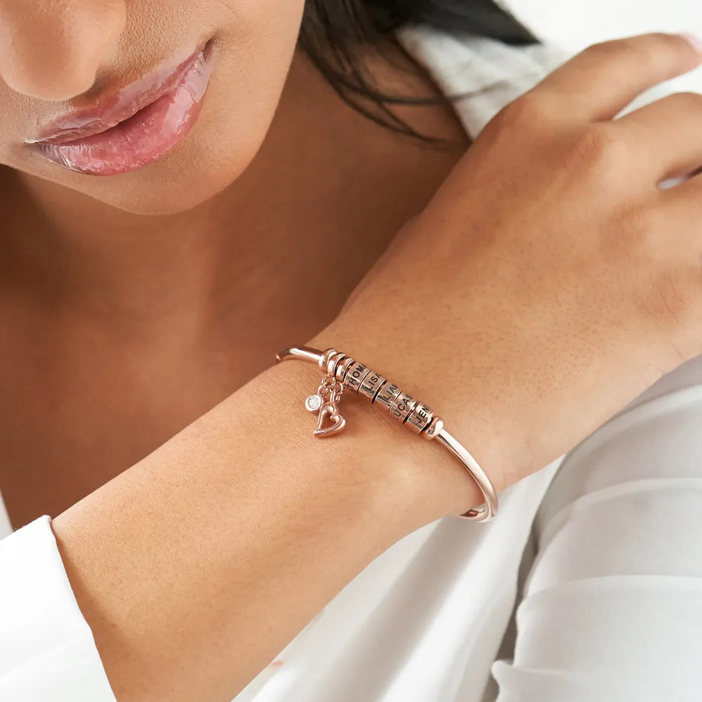 Woman wearing the Rose-gold plated bangle bracelet on her wrist 