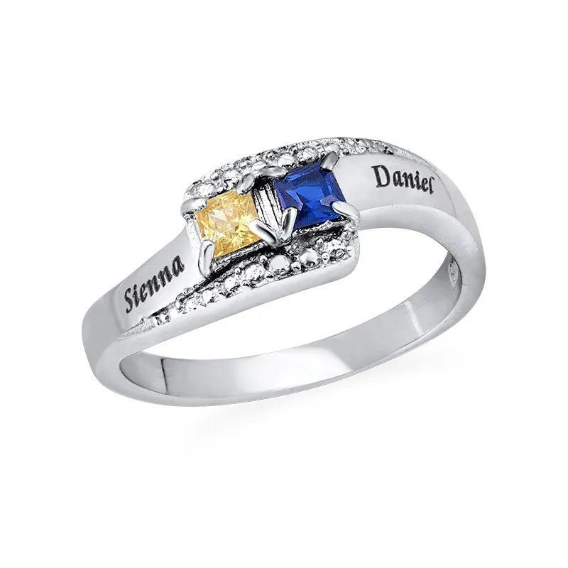 Stock image of an engraved  ring with two birthstones