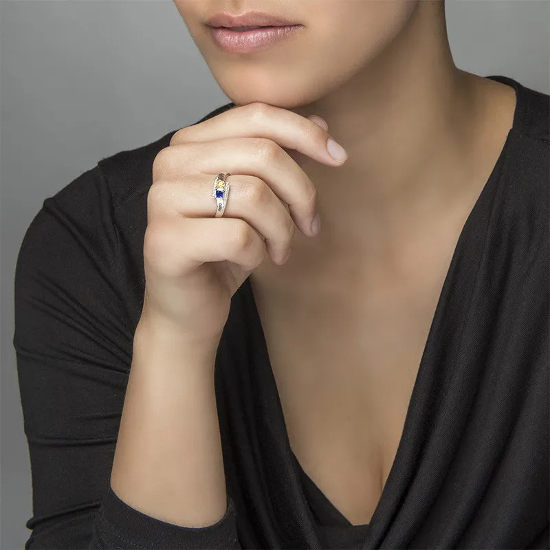 Woman wearing an engraved ring with two birthstones 