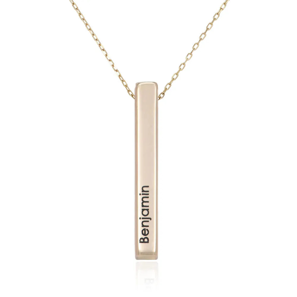 Stock image of a gold plated necklace with an inscribed vertical pendant 