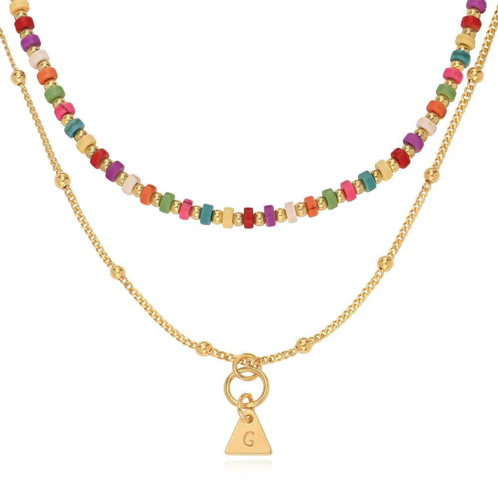 Stock image of a layered beads necklace with a Gold Initials pendant 