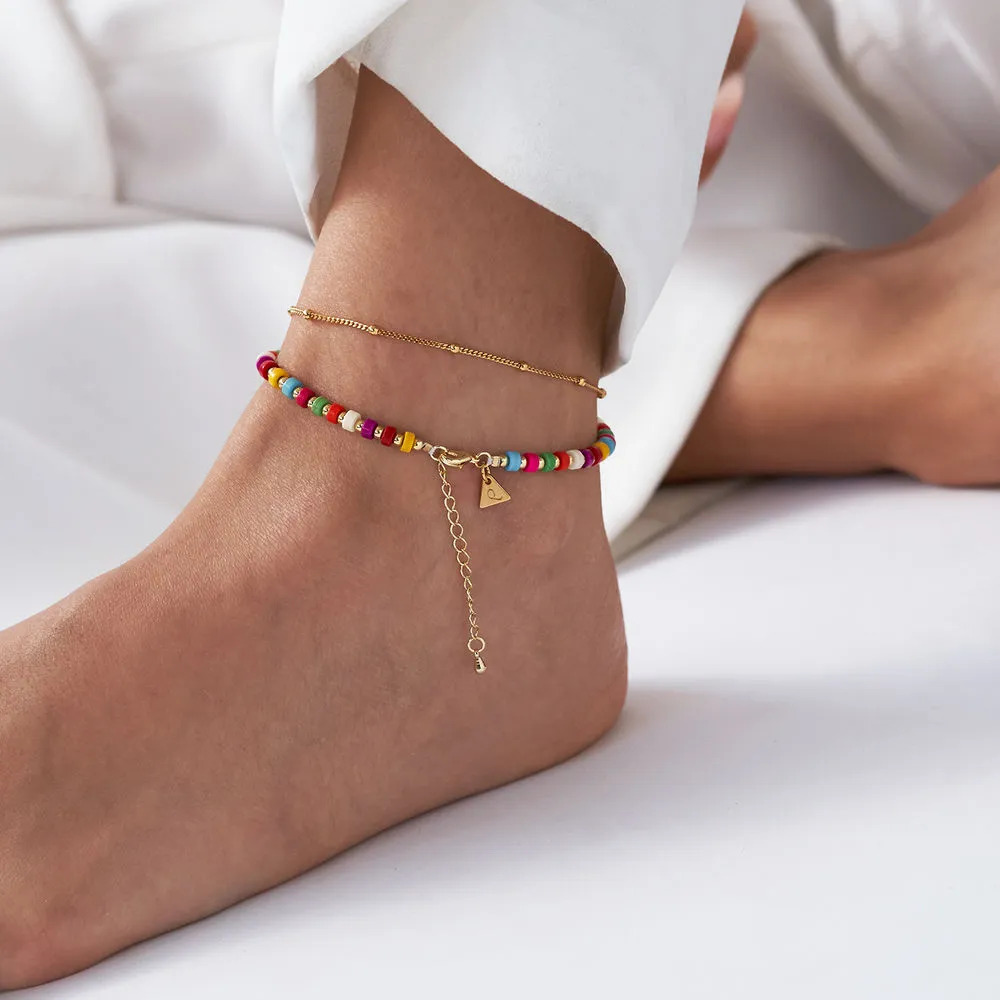 Woman wearing a layered tropical beads Anklet on her ankle 