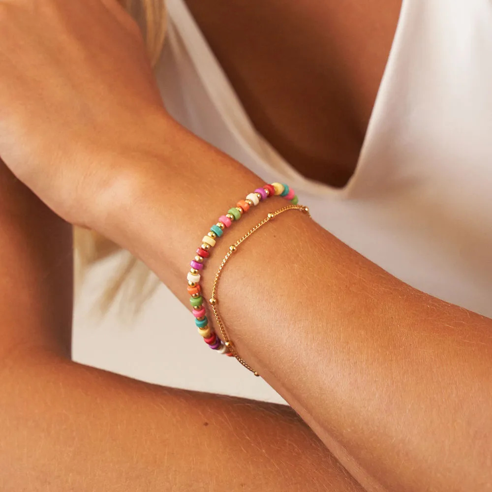 Woman wearing a layered tropical beads bracelet on her wrist 