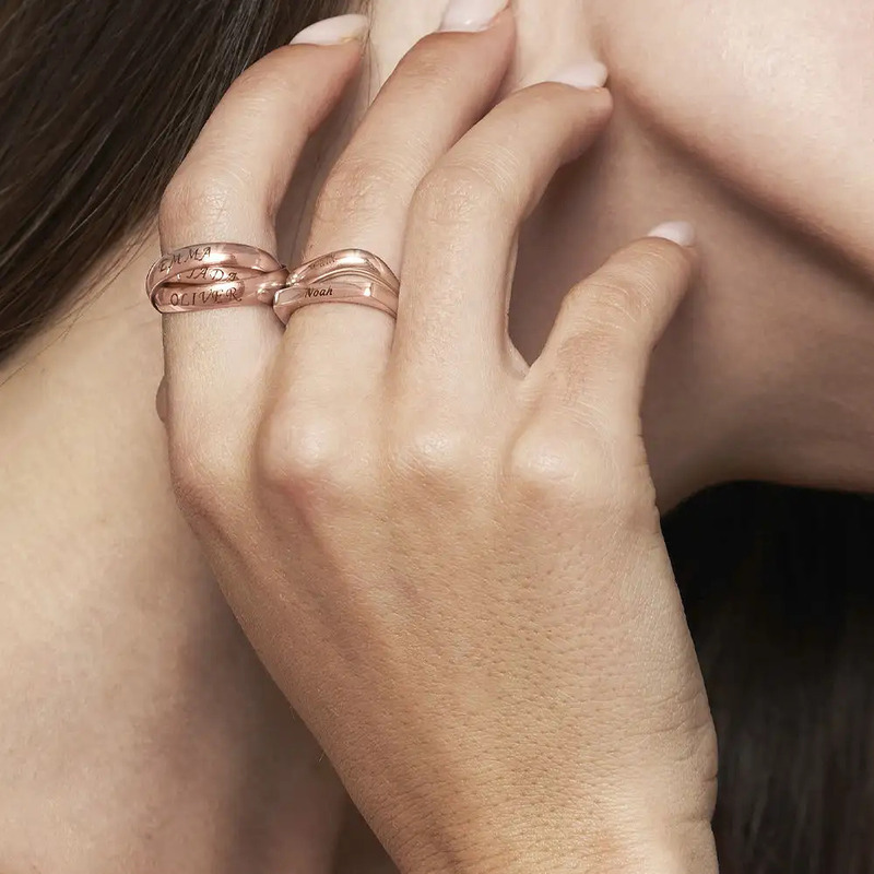 Woman wearing two rose gold Russian rings with engravings