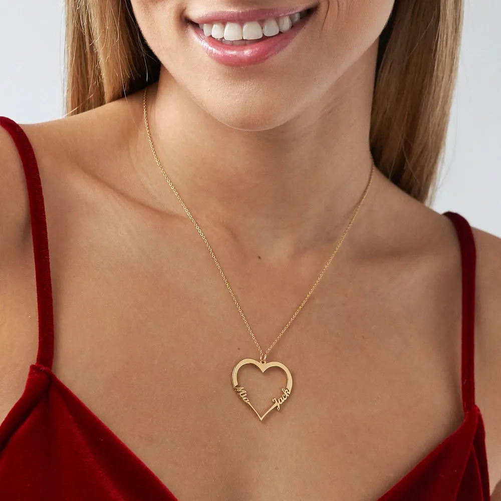 Woman smiling and wearing a heart-shaped gold name necklace