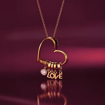 a gold necklace with a heart and the word love on it