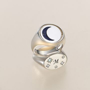 two silver rings with a crescent and stars on it