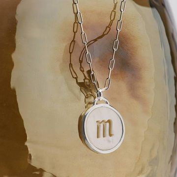 a necklace with the letter m on it