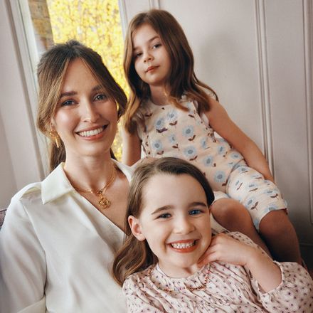 a woman sitting next to a little girl on her lap