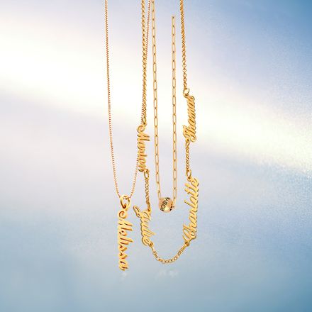 3 Gold necklaces hanging on a blue background