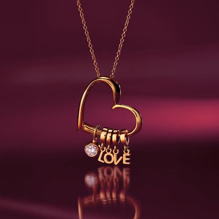 a gold necklace with a heart and the word love on it