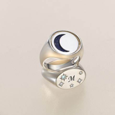 two silver rings with a crescent and stars on it