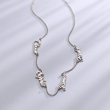 A white gold necklace with multiple names on it