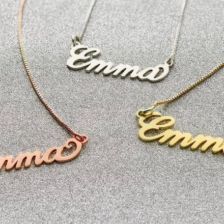 three different name necklaces sitting on a table