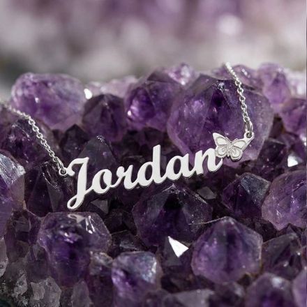 a close up of a bunch of rocks with a Jordan name necklace on it