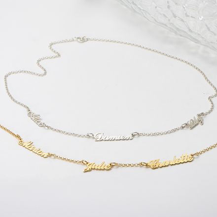 a couple of necklaces that are sitting on a table in White Gold and Yellow Gold