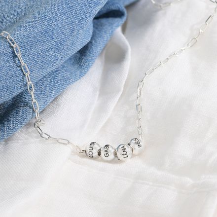a close up of a necklace on a white shirt