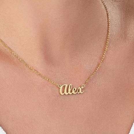 a woman wearing a gold necklace with the word alex on it