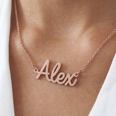 a woman wearing a necklace with the word alex on it