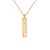 Stock image of a gold necklace with an inscribed vertical tile pendant