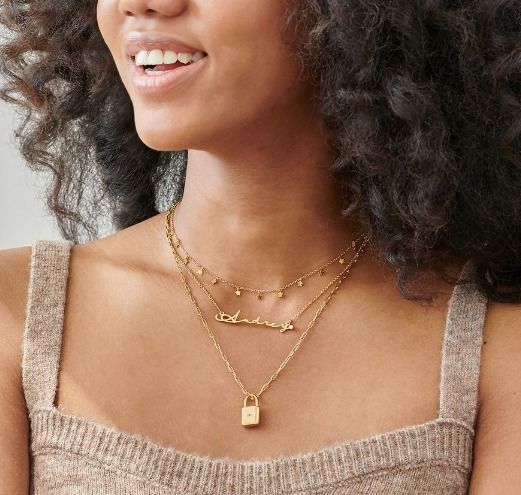  layered with a shorter and a longer gold necklaces