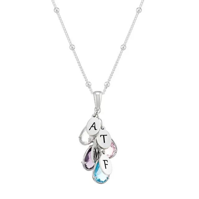 a silver birthstone necklace with four charms on it
