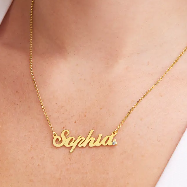 a woman wearing a gold necklace with the word sophia on it