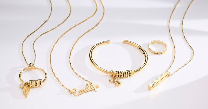 different types of gold jewelry on a white surface