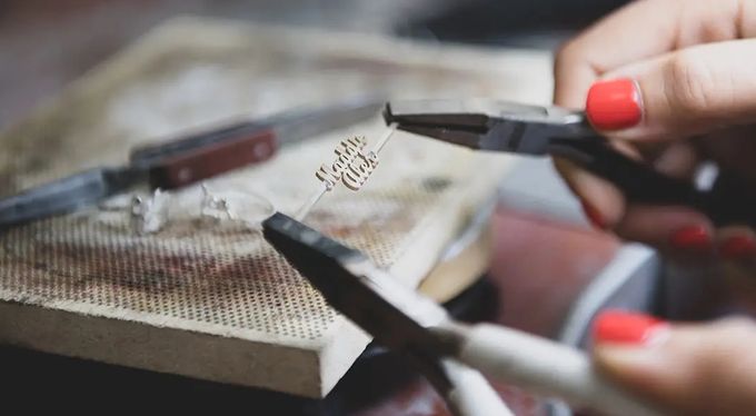 a woman is cutting a piece of paper with scissors