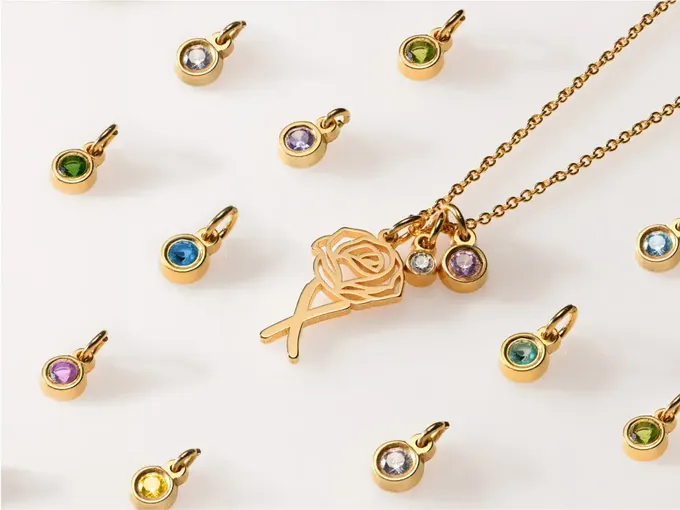 a collection of necklaces and pendants on a white surface