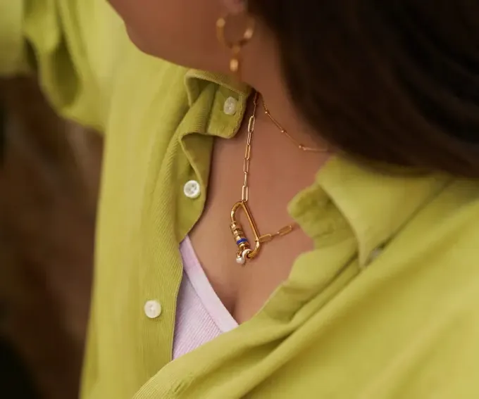a close up of a woman wearing a yellow shirt