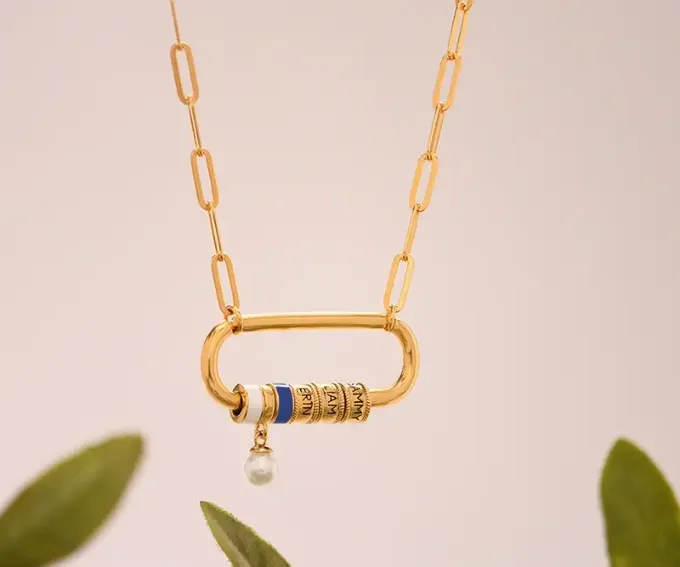 a gold necklace with a blue bead hanging from it