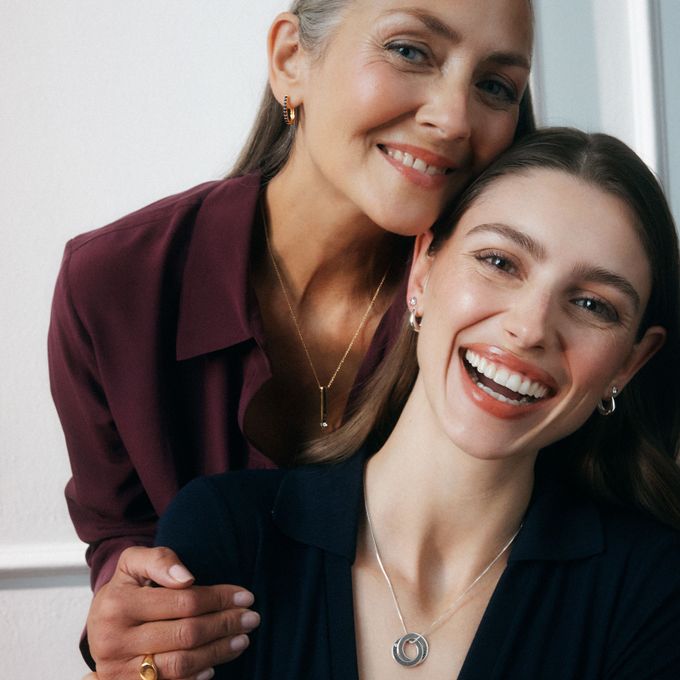 two women are smiling and posing for a picture