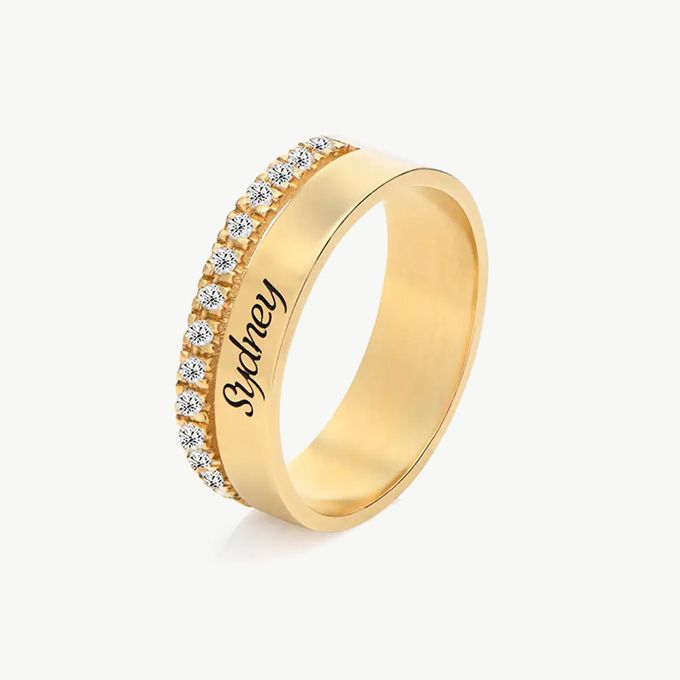 a gold ring with a name engraved on it