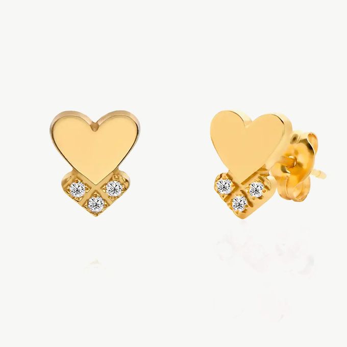 a pair of heart shaped earrings with diamonds