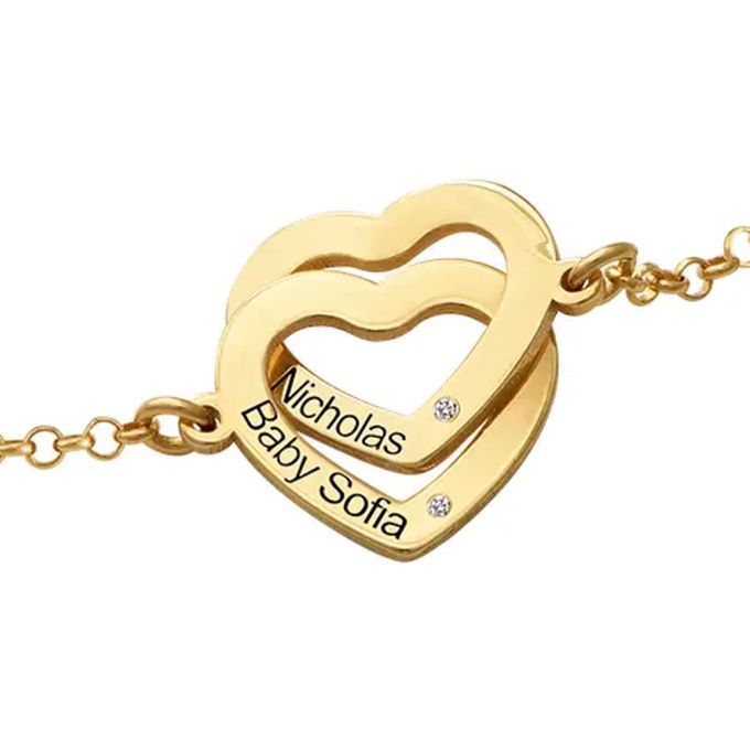 a heart shaped necklace with two names on it