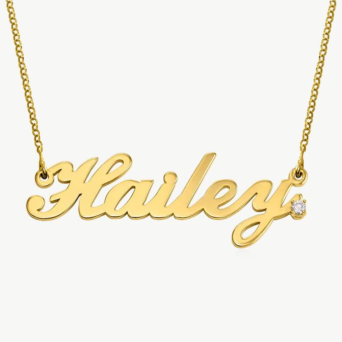 a gold name necklace with a diamond on it