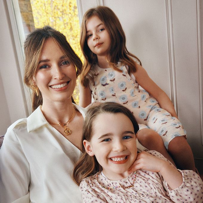 a woman sitting next to a little girl on her lap