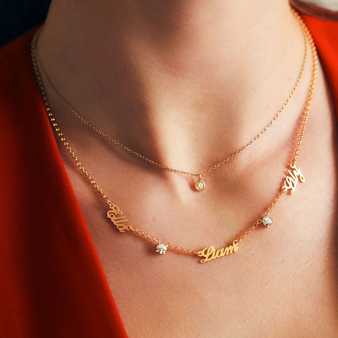 a close up of a woman wearing a gold necklace