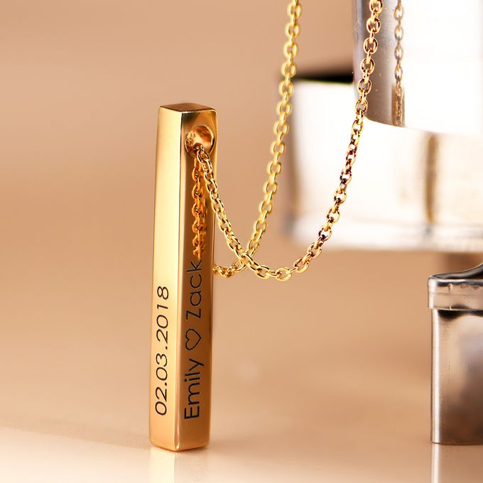 a close up of a gold bar on a chain
