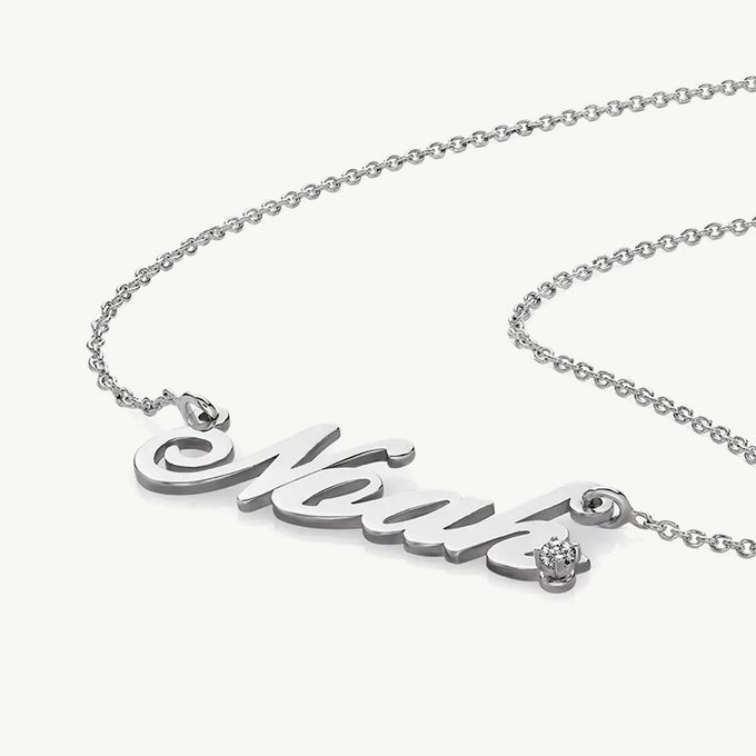a silver necklace with the name Noah on it