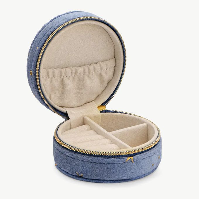an open blue velvet jewelry box with gold trim