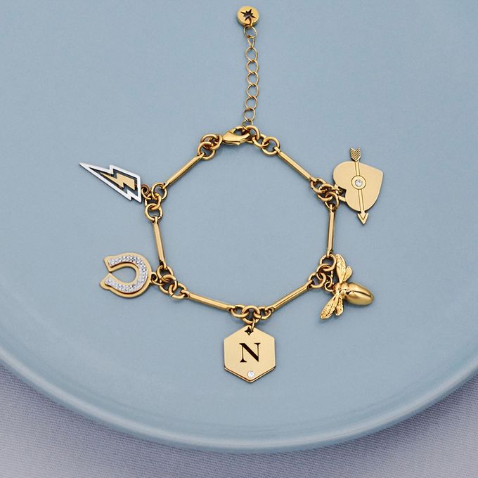 a blue plate with a gold charm bracelet